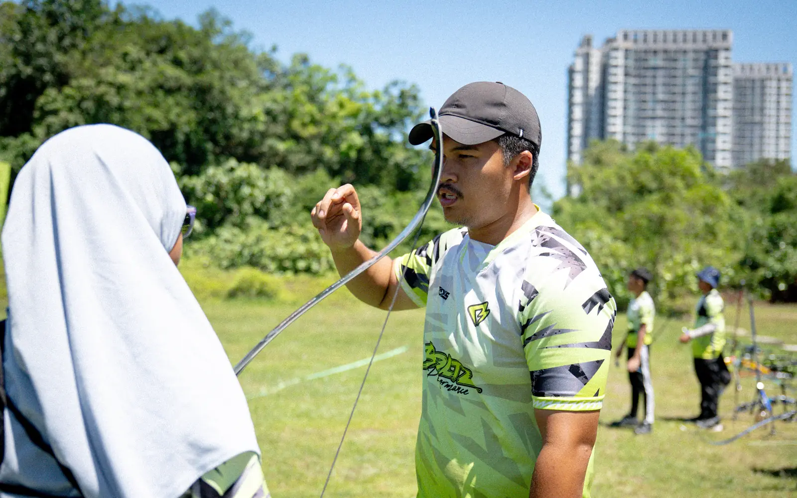 A Boltz coach demonstrating the string hand to a student on the field
